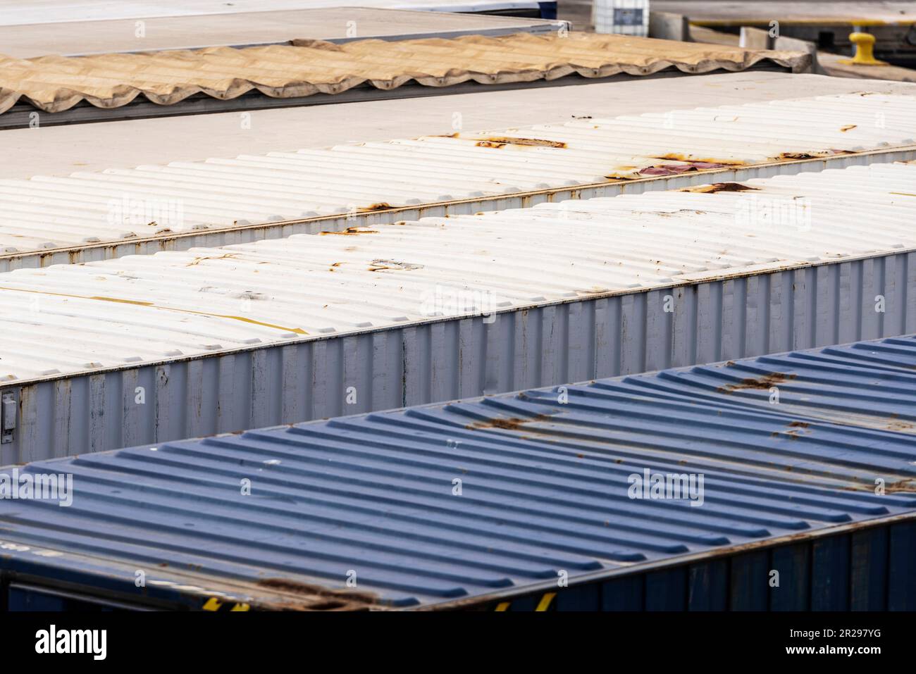 Container trailers parked in a row in the loading dock at the port of Barcelona, Catalonia, Spain Stock Photo