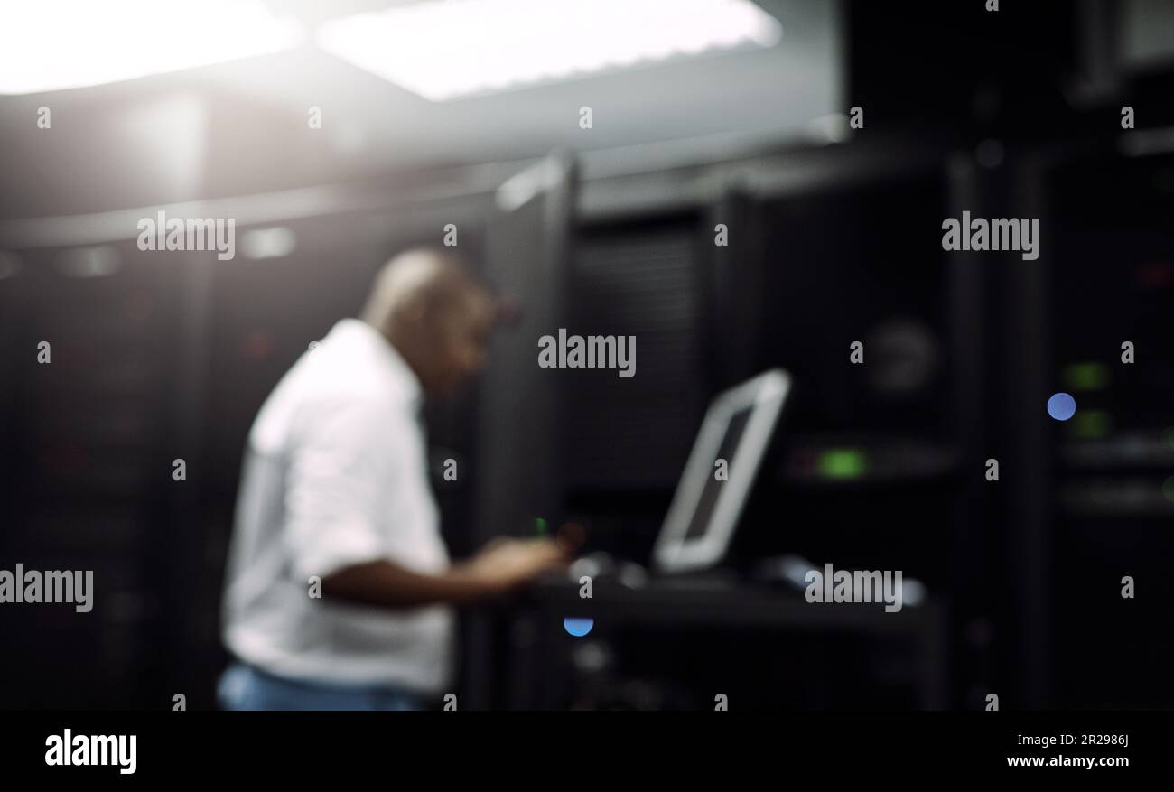 Code, black man or coding on computer in server room for big data, tech glitch or digital website. IT support, blurry or technician typing on laptop Stock Photo