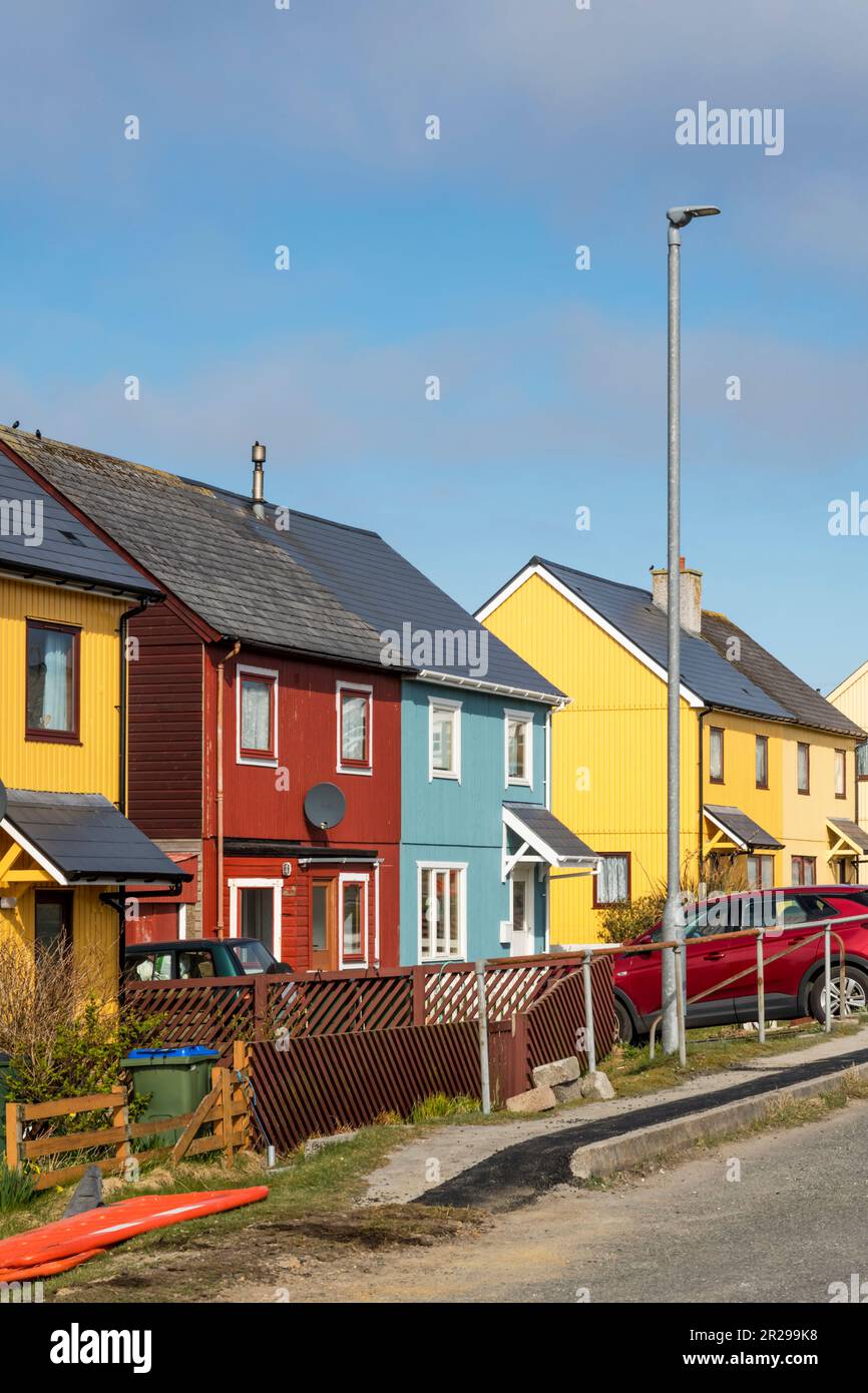 Bright coloured cladding on houses at Burravoe in the south of the
