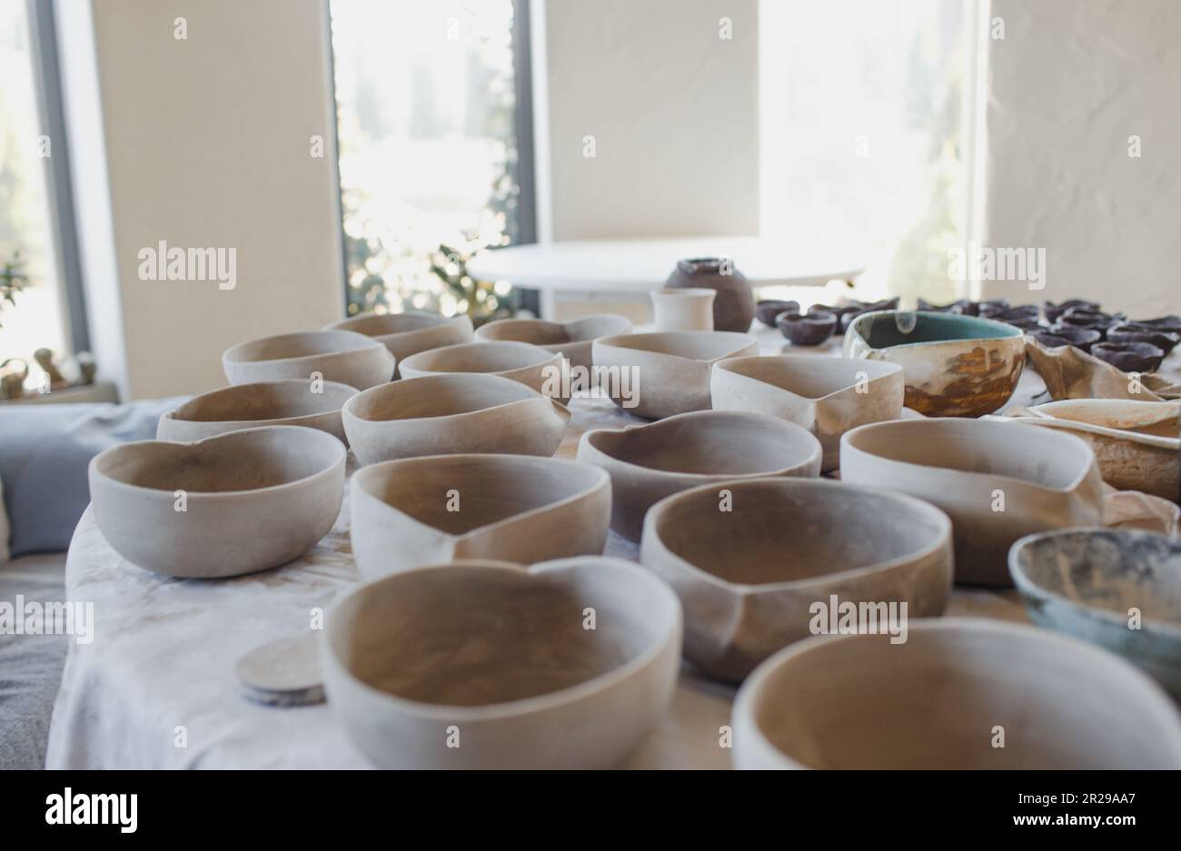 clay plates on the table, pottery work. Stock Photo