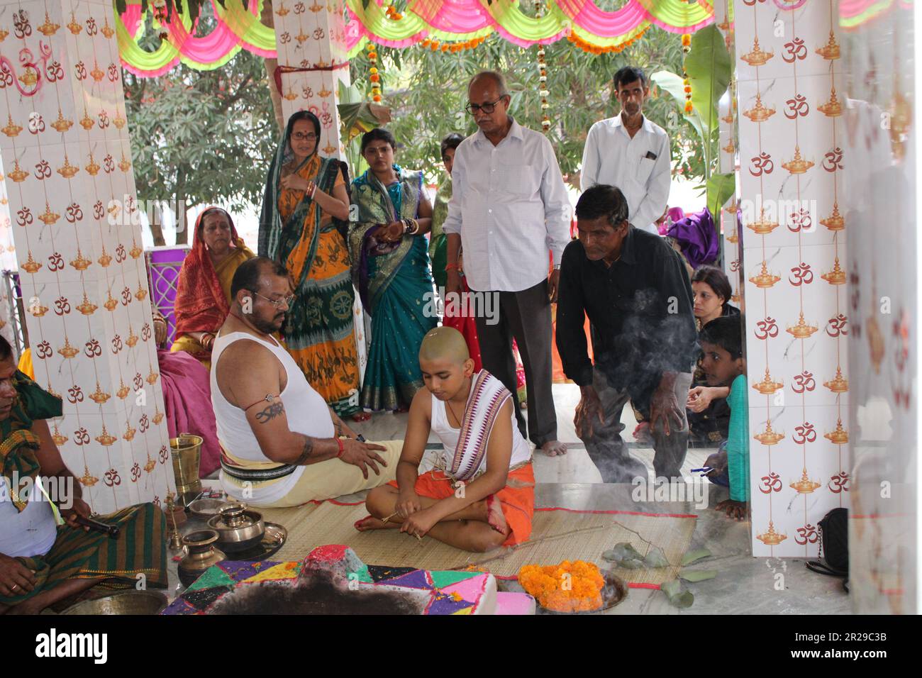 Upanayana sanskara ceremony in progress. Traditionally, this ritual was for 7, 9, and 11 year olds in South Asia, but is now practiced for all ages. Stock Photo