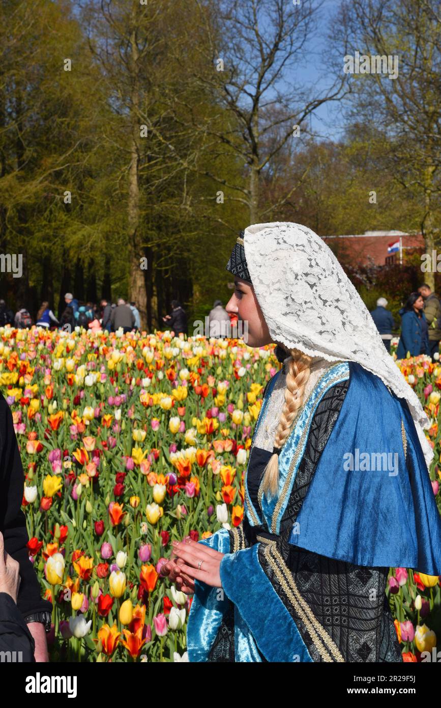 Lisse, Netherlands. April 2023. The girl with the pearl earrings in a tulip field at the Keukenhof. High quality photo Stock Photo