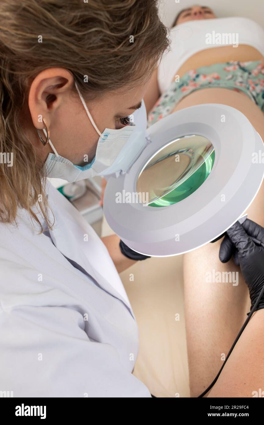 Beautician Does Hair Removal Electrolysis Procedure On Woman's Leg, Shin. Electric Epilation In