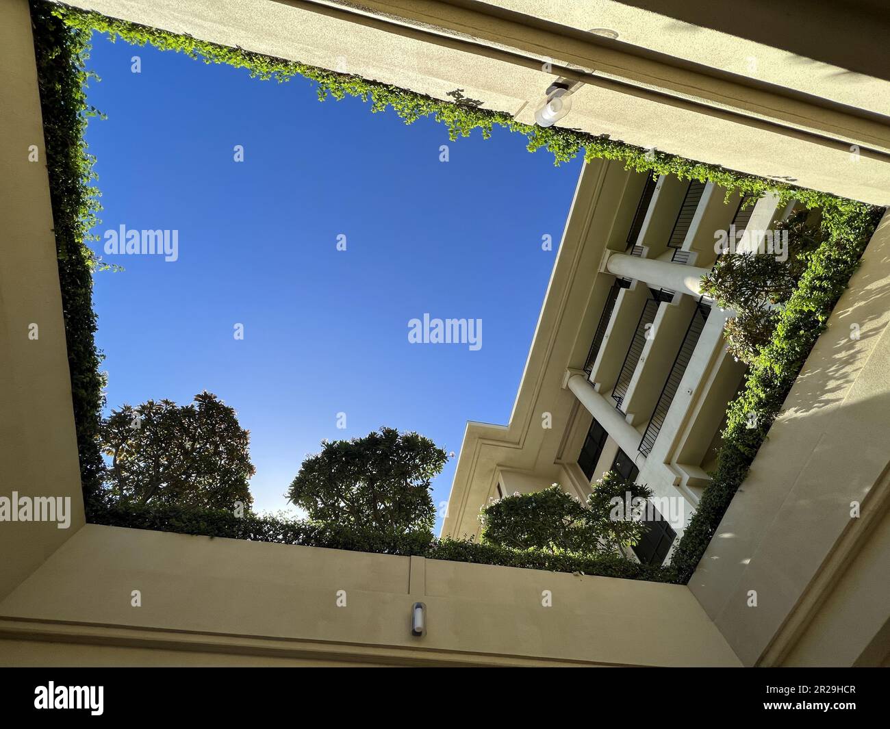 Lowangle view looking up through open ceiling to garden area at the Four Seasons Resort Maui at