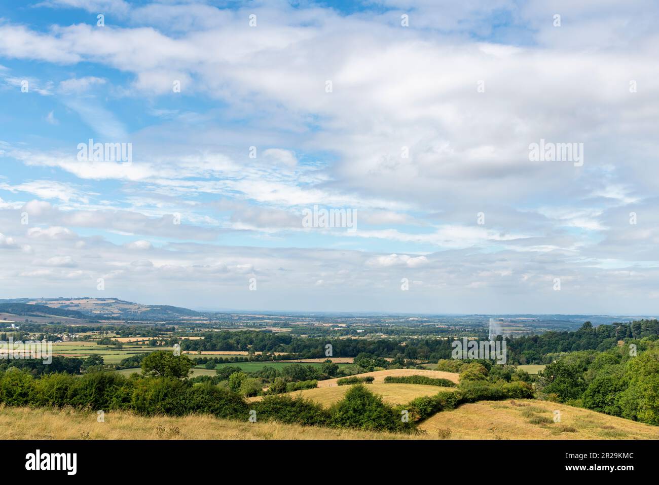 Panoramic view from a hill over the Cotswolds landscape near Stanway, Cheltenham, UK, with visible worlds highest gravity fountain against white cloud Stock Photo