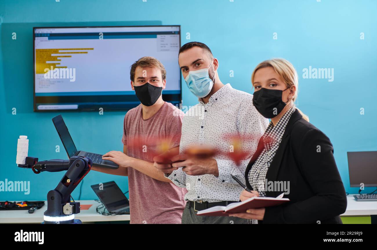A group of students working together in a laboratory, dedicated to ...
