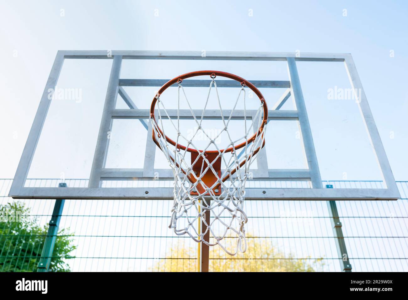Action shot of basketball going through basketball hoop and net Stock
