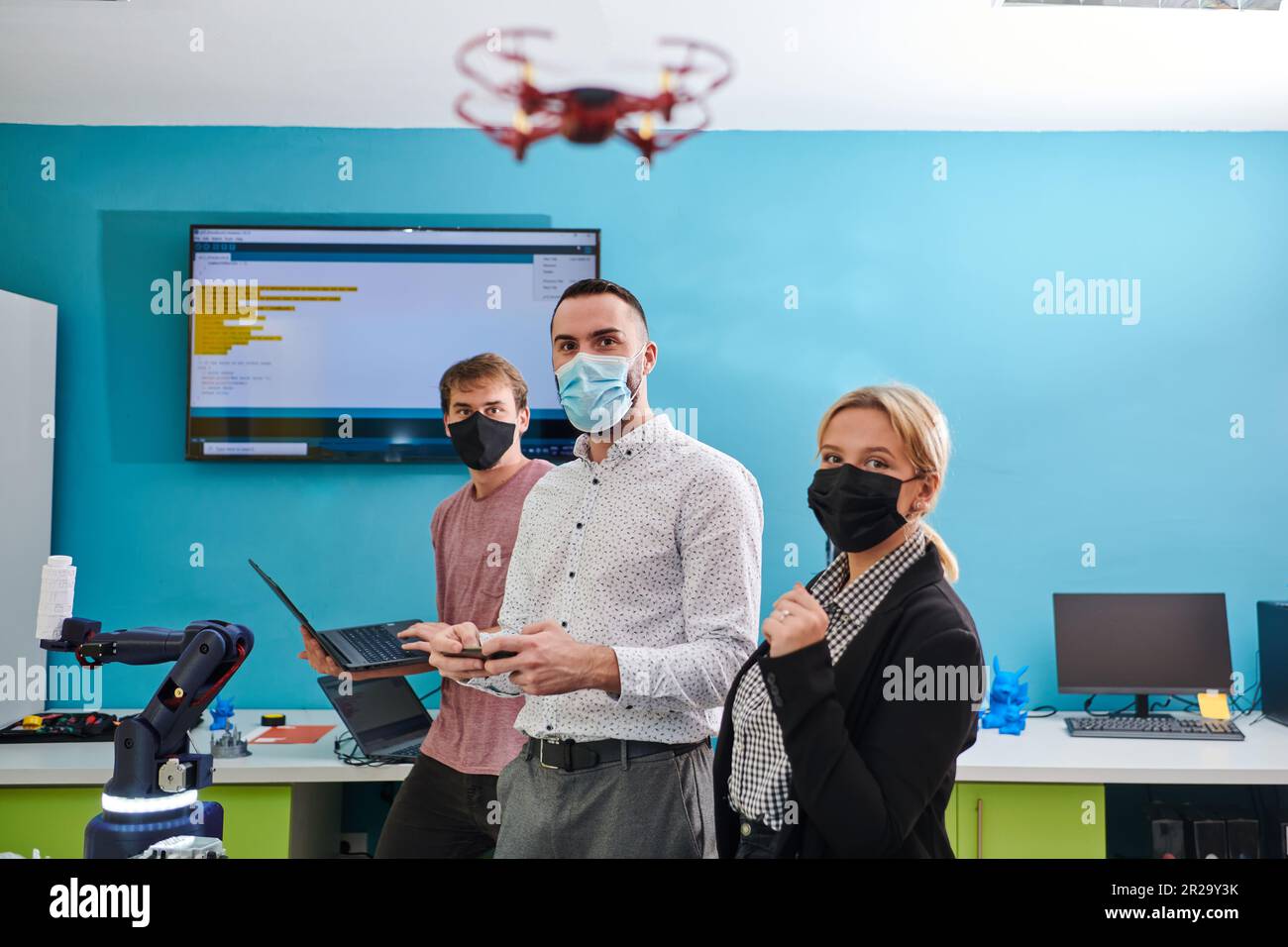 A group of students working together in a laboratory, dedicated to ...