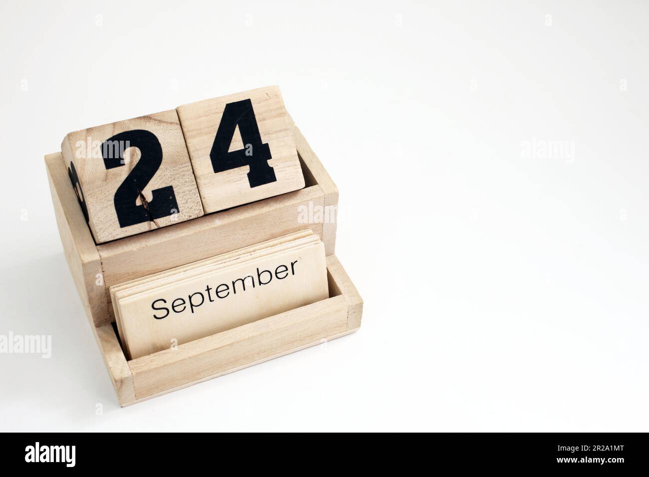 Wooden perpetual calendar showing the 24th of September Stock Photo - Alamy
