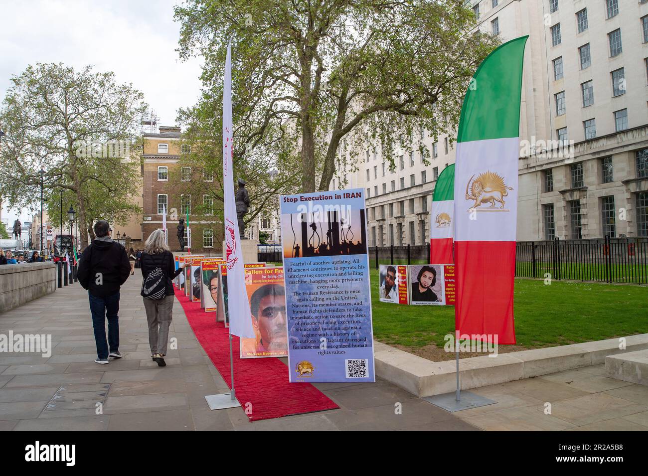 Whitehall, London, UK. 17th May, 2023. A Stop Execution in Iran Protest was held opposite Downing Street in London today. The protesters are calling on the Member States of the United Nations, including the UK,  to help change the 'Religious Dictatorship' Iranian regime. Photographs of those killed in Iran were put along a red carpet. Credit: DLeLife/Alamy Live News Stock Photo
