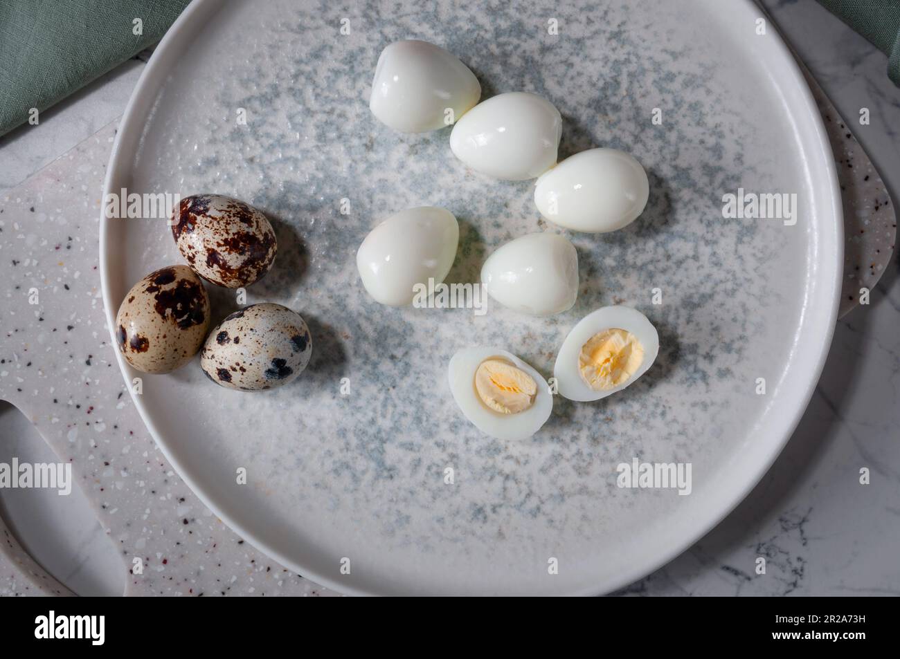 Boiled eggs lying on a plate, on a board. Useful and tasty ingredient. Stock Photo