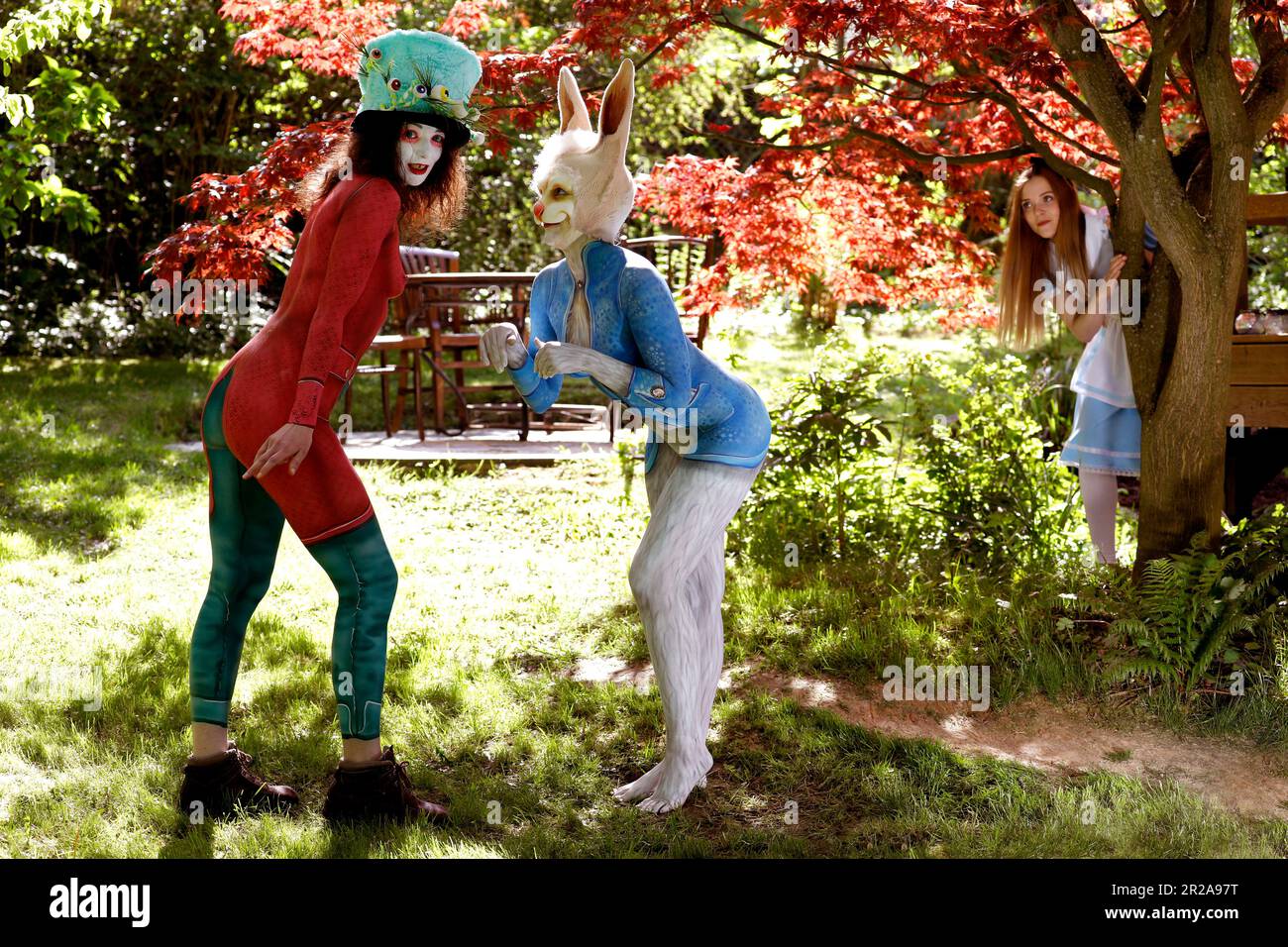 GEEK ART - Bodypainting and Transformaking: Alice in Wonderland photoshooting with Melina as Alice, Julia as the Mad Hatter and Janina as the White Rabbit in the Czarnecki Garden. Hamelin on May 18, 202 - A project by photographer Tschiponnique Skupin and bodypainter Enrico Lein Stock Photo
