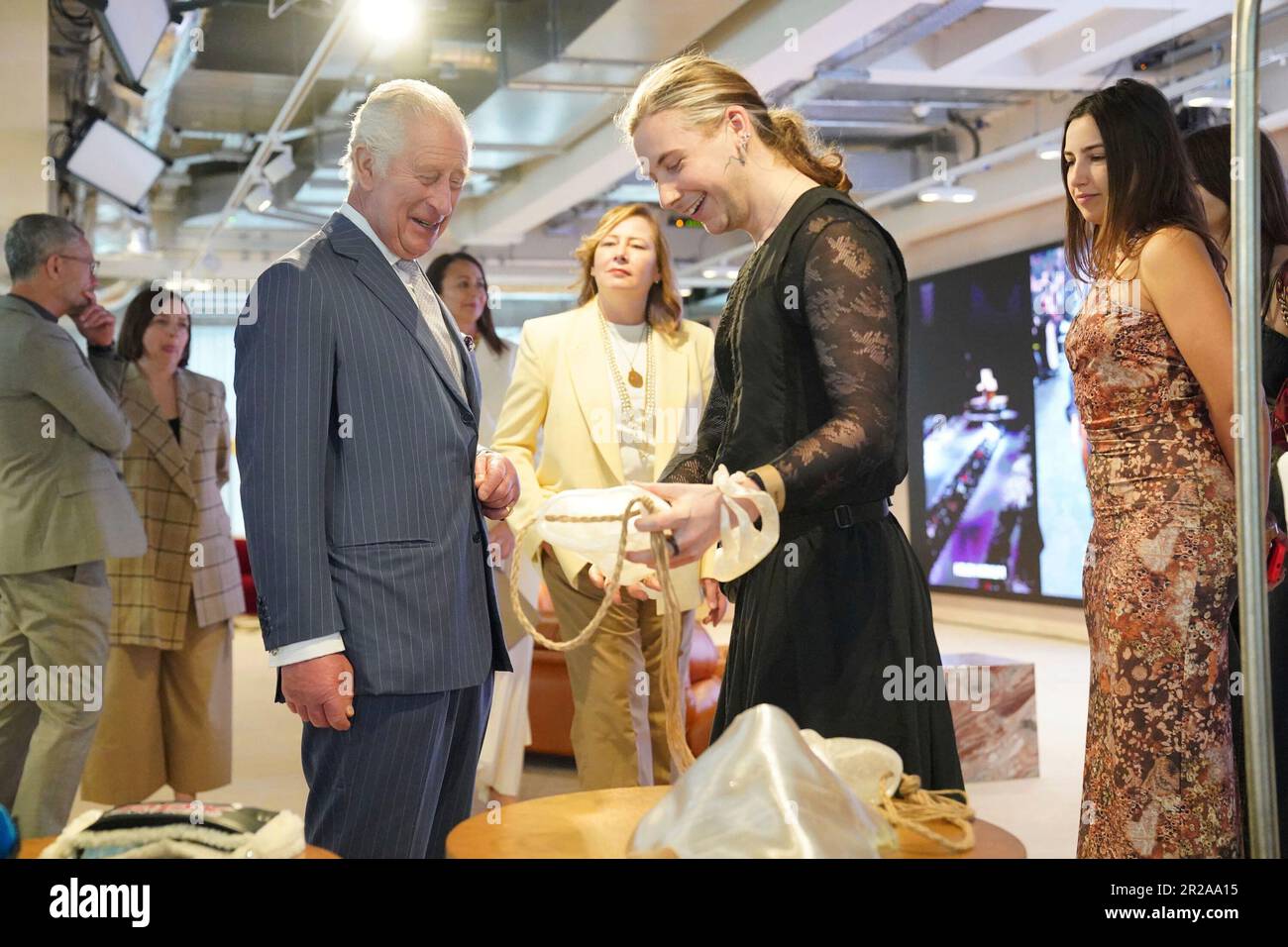 Designer Leo Carlton, shows King Charles III a handbag made from fermented  corn starch during a special industry showcase event hosted by the British  Fashion Council (BFC) in London, Thursday May 18