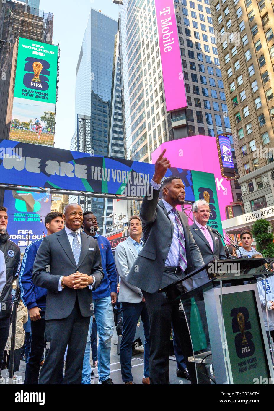 New York, USA. 18th May, 2023. Former footballer Michael Strahan (C) is flanked by New York City Mayor Eric Adams (L) and New Jersey Governor Phil Murphy (R) at a FIFA World Cup 2026 New York/New Jersey Launch Event in Times Square. The event unveiled the official themes for the MetLife stadium matches: 'We are NYNJ' and 'We are 26'. The world's top soccer competition is already planning to host 8 matches in the New York/New Jersey area and the local organizers want to host the final game here too. Credit: Enrique Shore/Alamy Live News Stock Photo