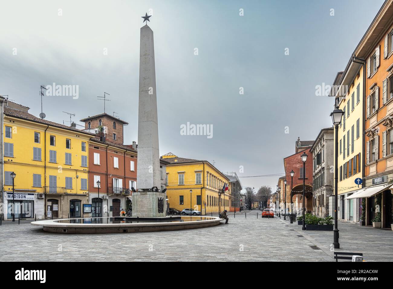 The obelisk in the middle of a body of water in Piazza Gioberti, which connects Corso Garibaldi to the Via Emilia in the historic centre.Reggio Emilia Stock Photo