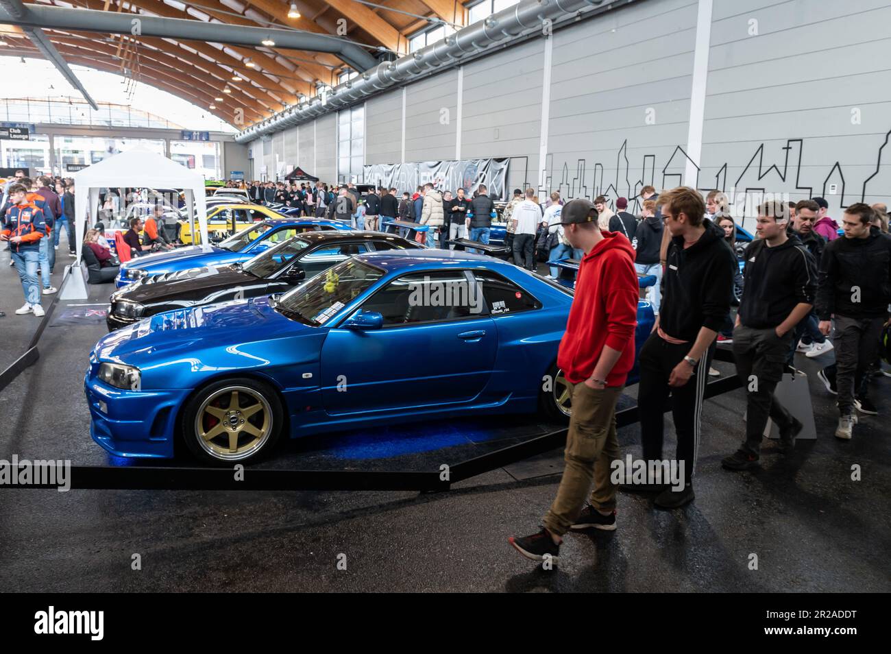Friedrichshafen, Germany. 18th May, 2023. Visitors look at cars on