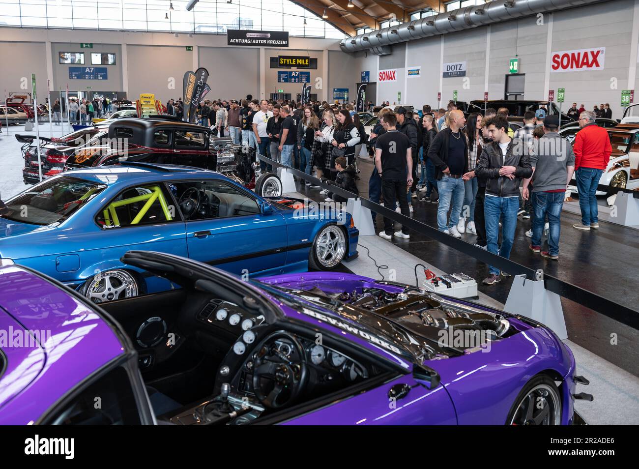 Friedrichshafen, Germany. 18th May, 2023. Visitors look at cars on