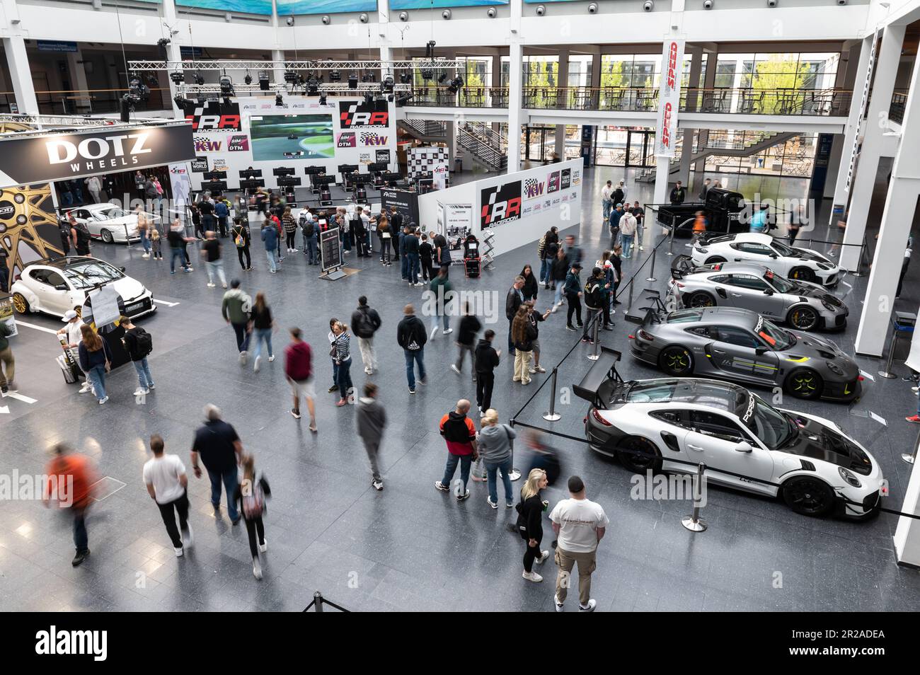 Friedrichshafen, Germany. 18th May, 2023. Visitors look at cars on