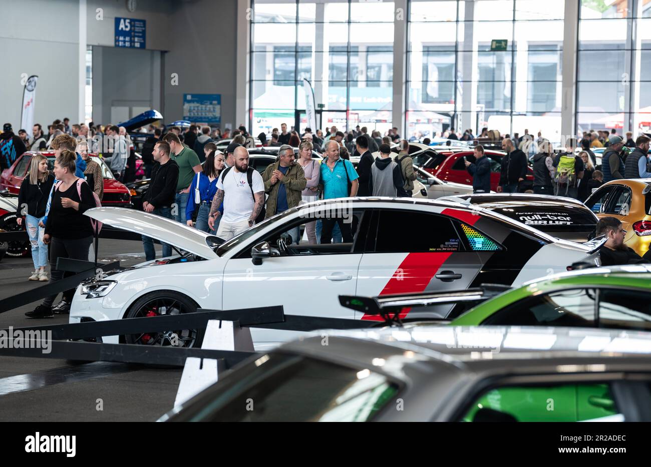Friedrichshafen, Germany. 18th May, 2023. Visitors look at cars on