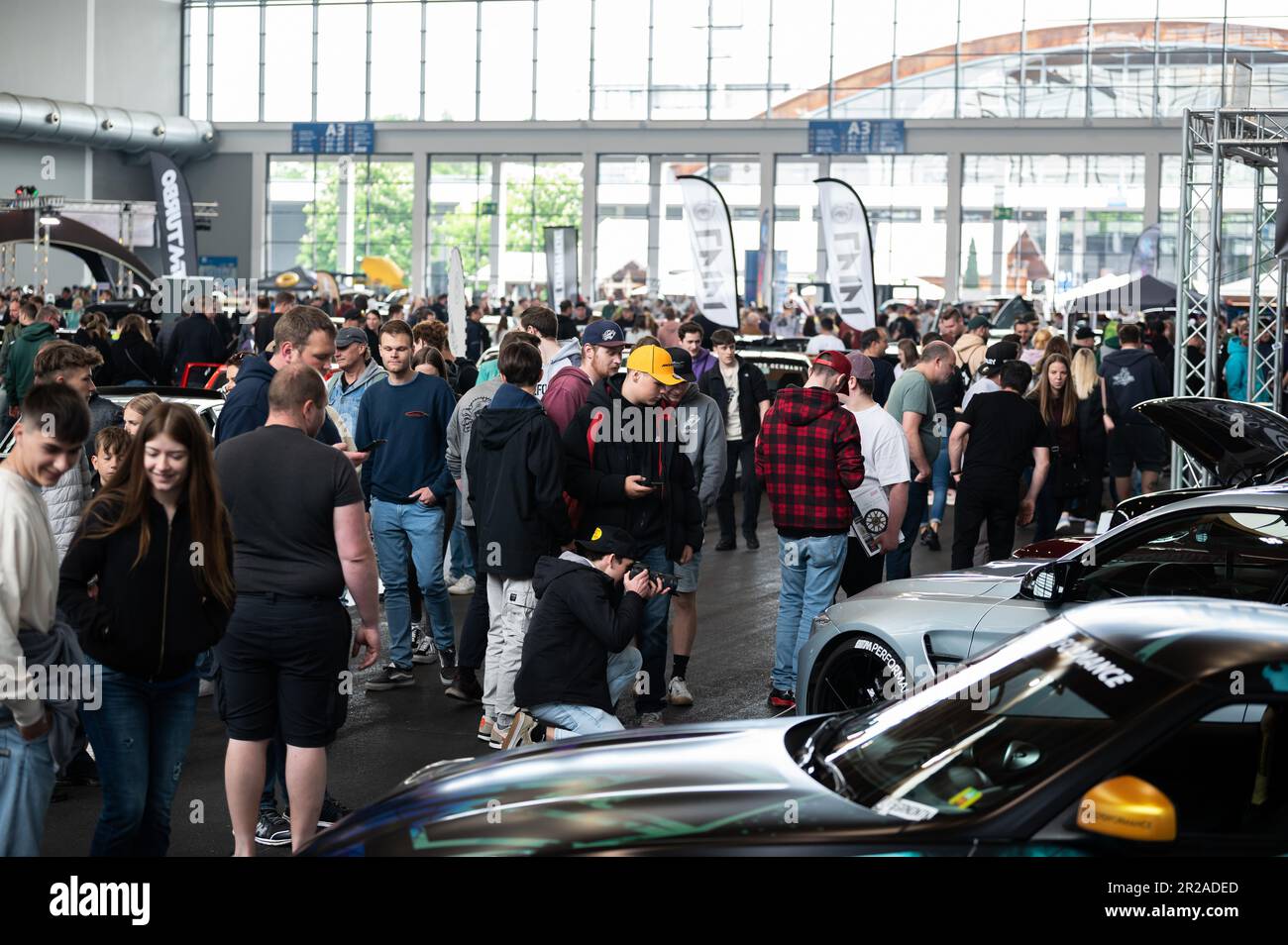 Friedrichshafen, Germany. 18th May, 2023. Visitors look at cars on