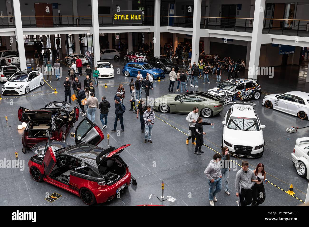 Friedrichshafen, Germany. 18th May, 2023. Visitors look at cars on