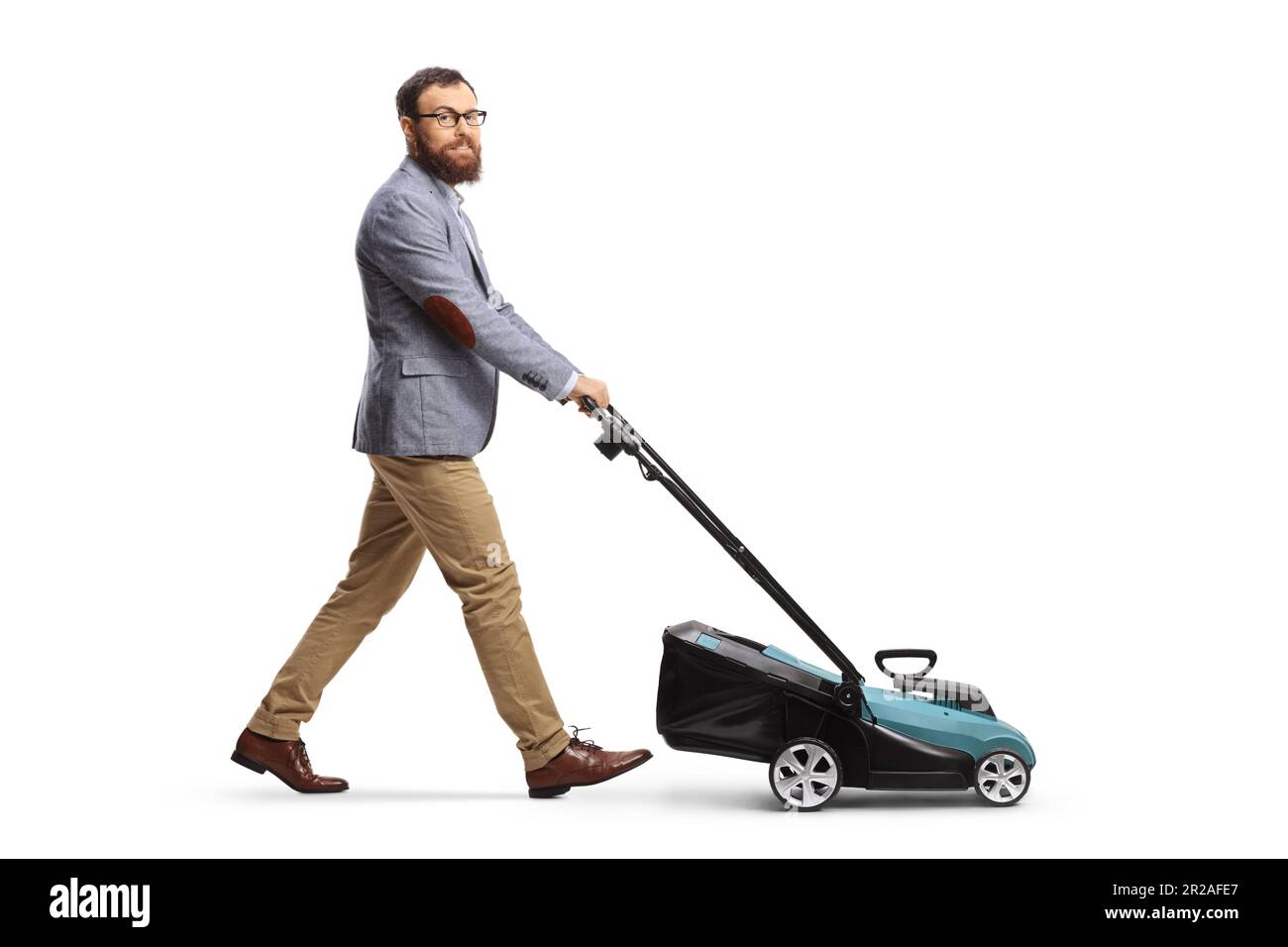Full length shot of a man using a lawnmower and looking at camera isolated on white background Stock Photo