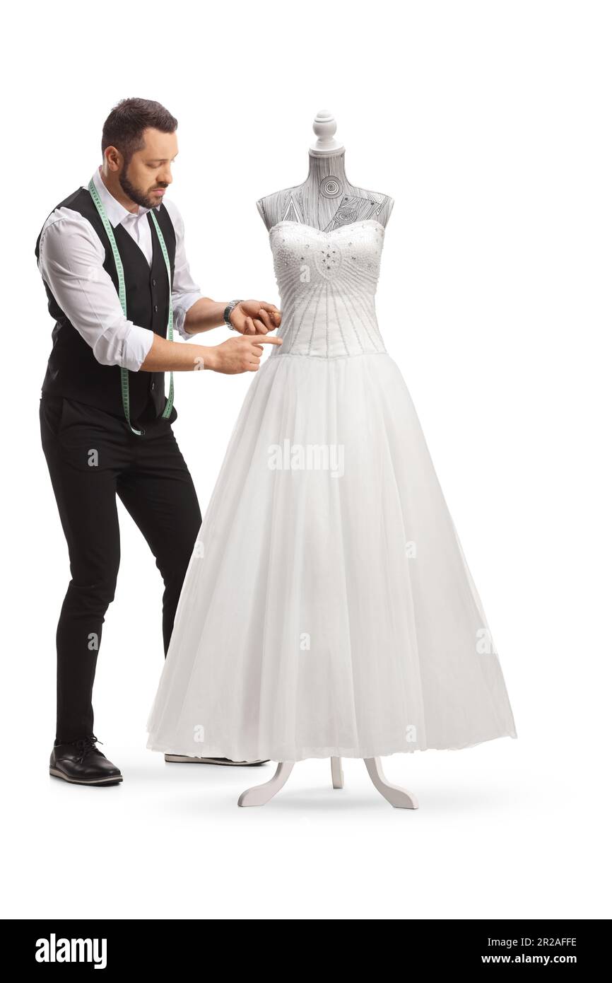 Tailor fitting a bridal gown on a mannequin doll isolated on white background Stock Photo