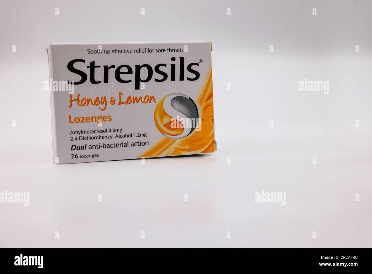 Box of Strepsils lozenges or medicine for sore throats and coughs, isolated against white background. Stock Photo