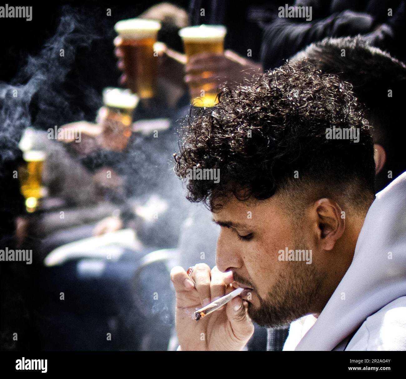 AMSTERDAM A tourist smokes a joint in the Red Light District. In the