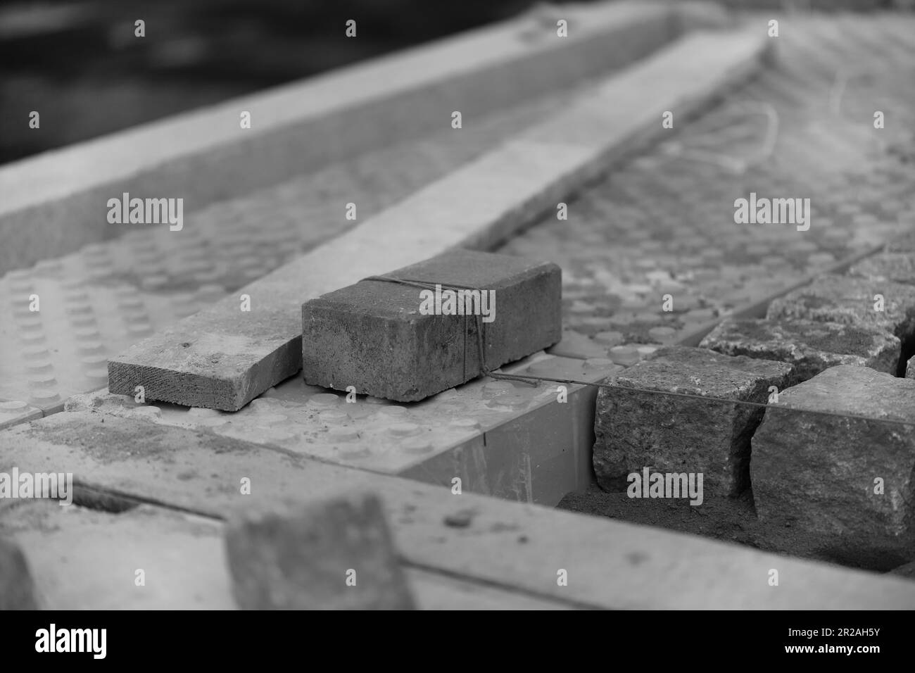 Cement paving stones wrapped with string Stock Photo Alamy