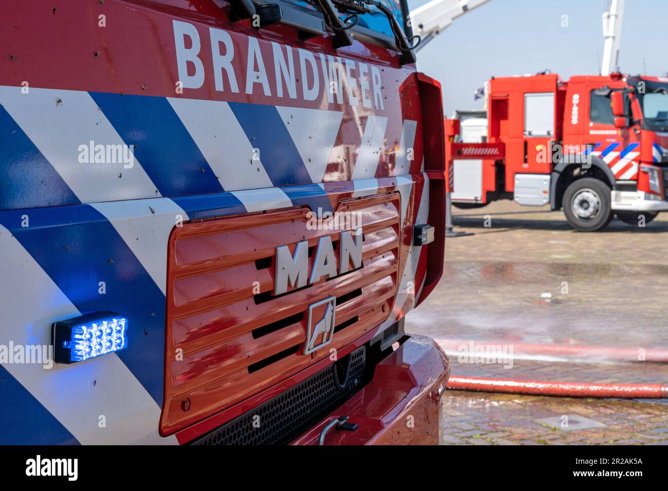 Dutch MAN LE fire engine with active blue emergency lighting Stock Photo