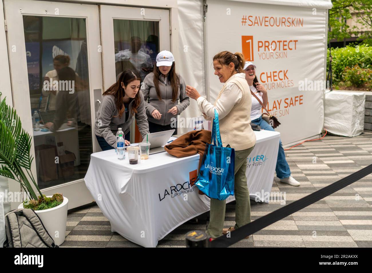 Visitors to Hudson Yards receive sunscreen samples after having their moles checked for skin cancer at a brand activation in Hudson Yards in New York for La Roche-Posay Laboratoire Dermatologique on Monday, May 1, 2023. La Roche-Posay is a brand of L’Oreal. (© Richard B. Levine) Stock Photo
