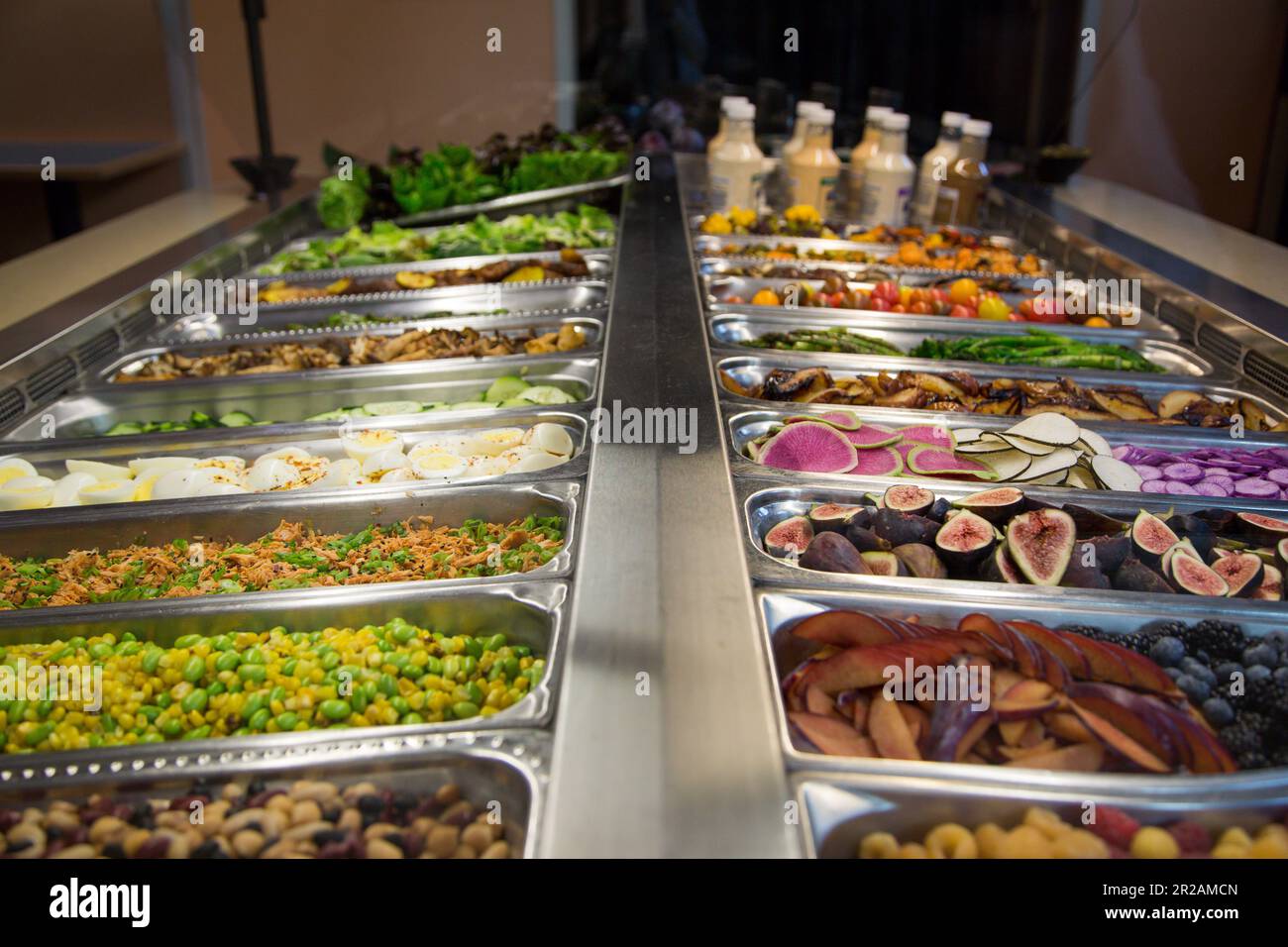 Food and salad bar with a large variety of fruits, vegetables, and