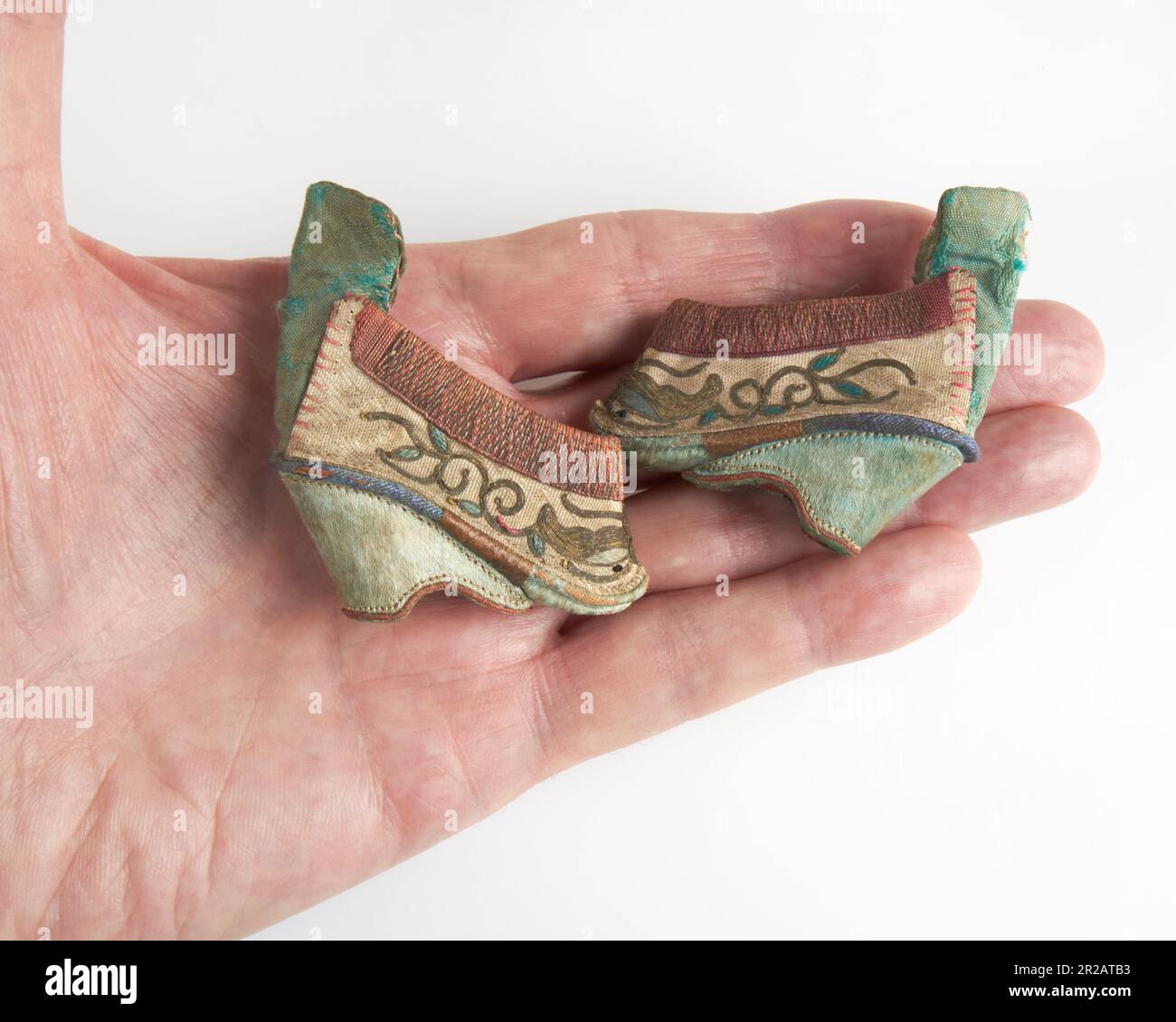 Rare pair of 19thc. Chinese dragon miniature 2 inch votive altar lotus silk shoes Stock Photo