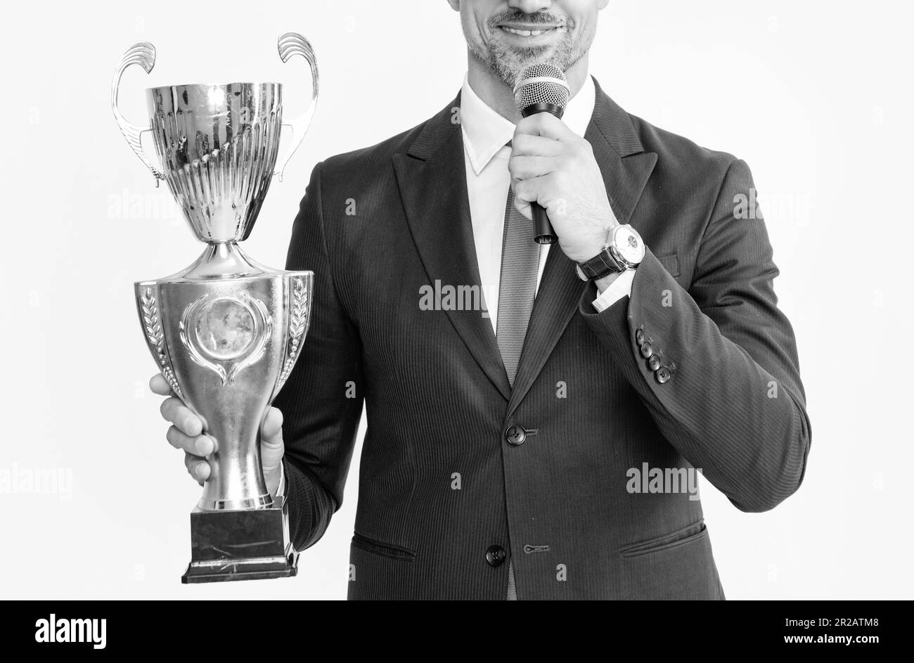 happy mature man in suit hold champion cup and microphone isolated on white background Stock Photo