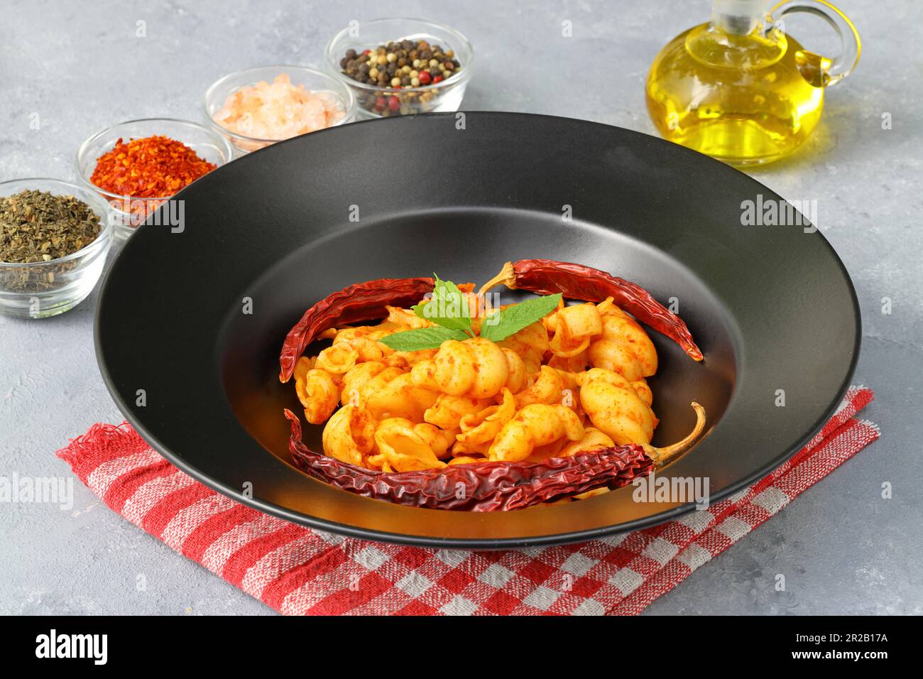 Gnocchetti sardi pasta in tomato sauce. gray background. Italian food concept Stock Photo