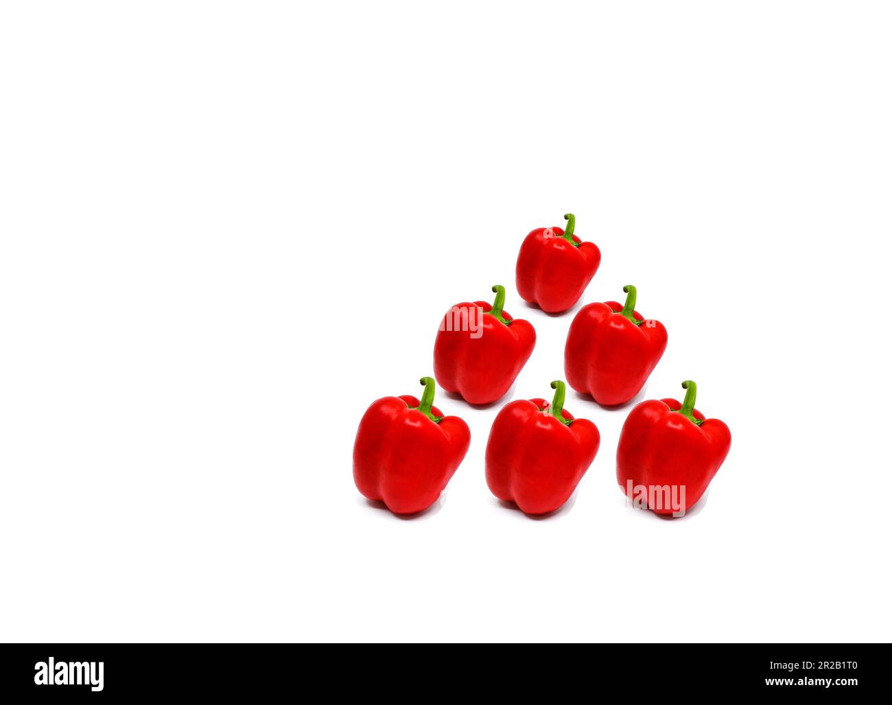 Red bell peppers isolated on a plain white background. Copy space. Stock Photo