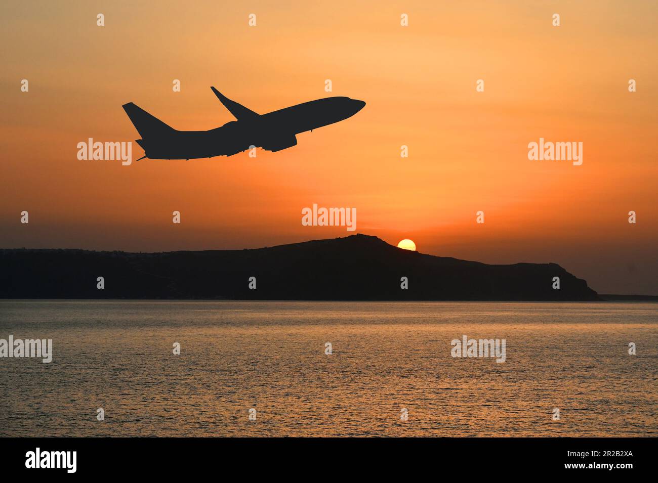 Holiday jet leaving a tourist destination at unset flying over the sea. No people. Travel concept. Copy space. Stock Photo