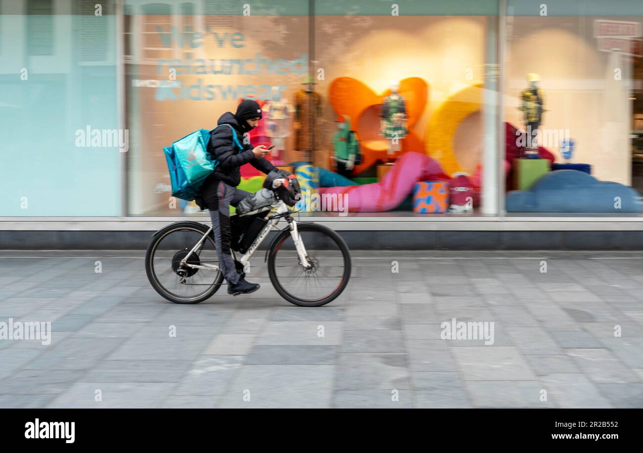 Deliveroo bike delivery man check his phone Stock Photo