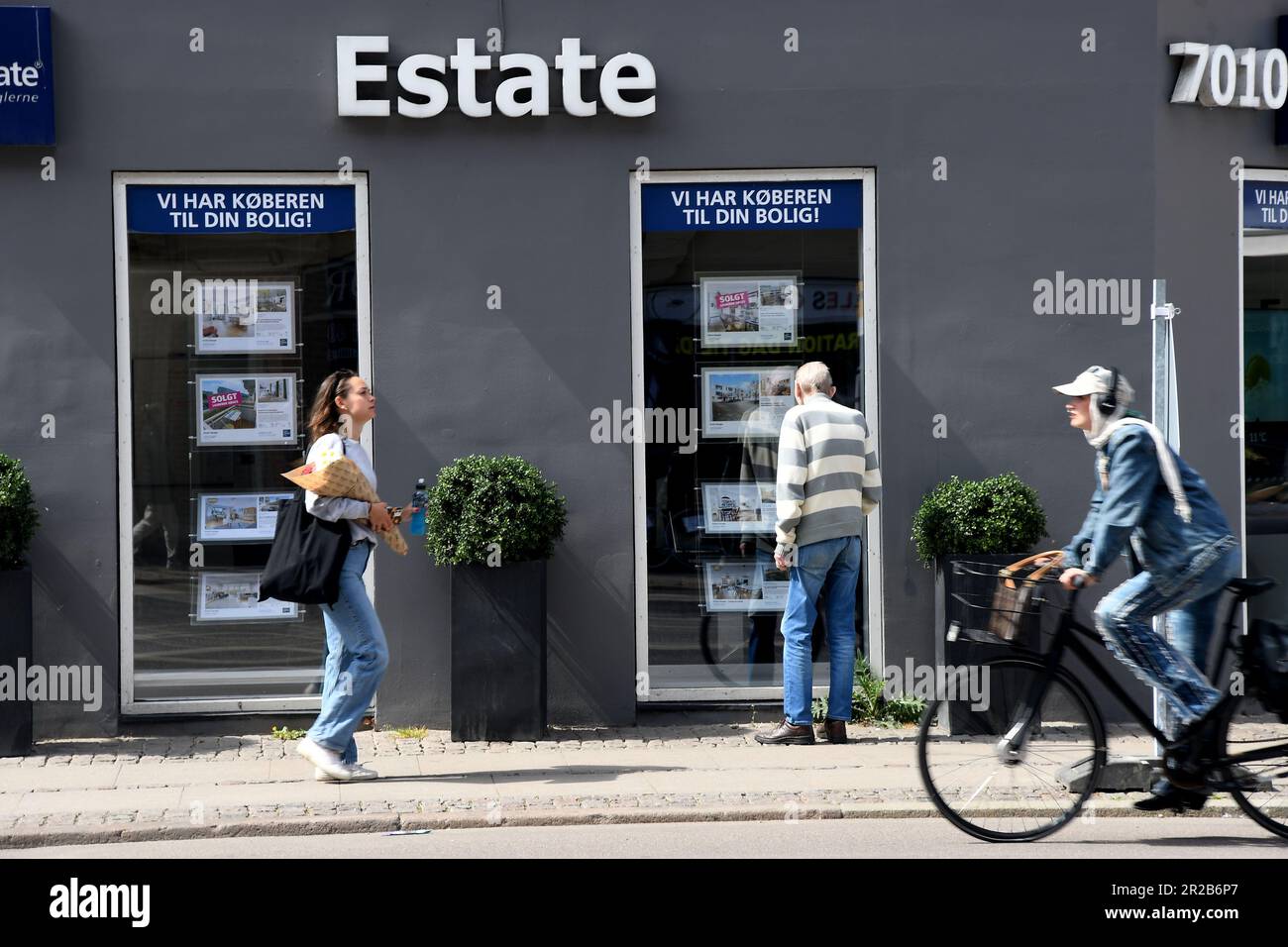 May 18,2023/Men looking house prices at playcard at real estate offiice