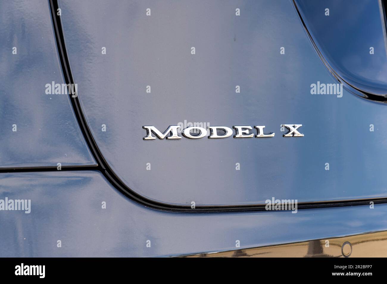 Tesla Model X badge or logo or insignia on the rear of a Tesla passenger car. Stock Photo