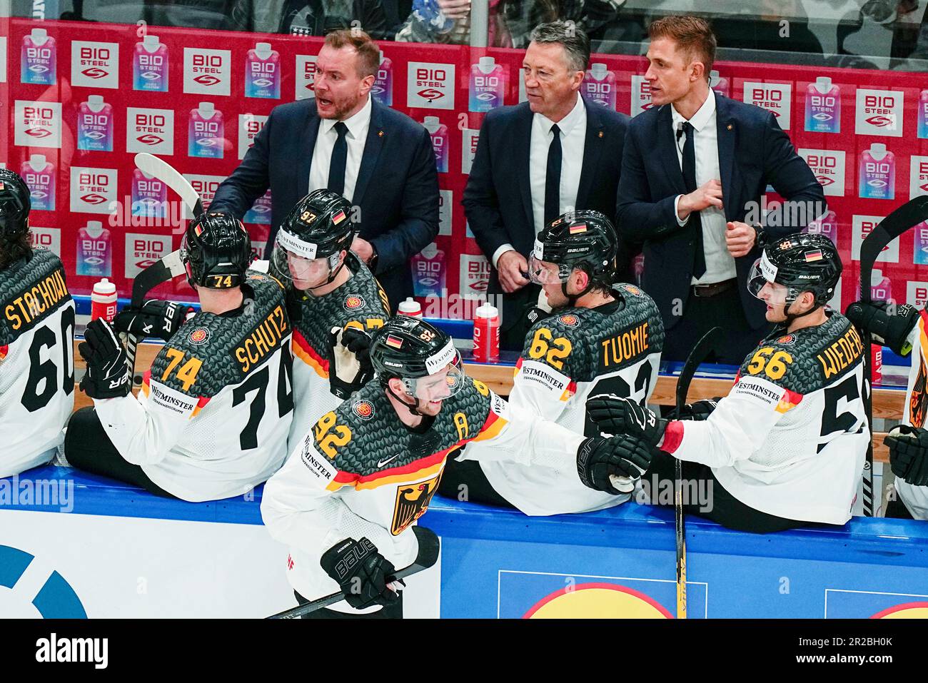Germany's head coach Harold Kreis, top centre, assistant coach Alexander  Sulzer, top right and assistant coach Pekka Kangasalusta react as Germany's  Marcel Noebels, bottom, celebrates after scoring his side's fifth goal  during
