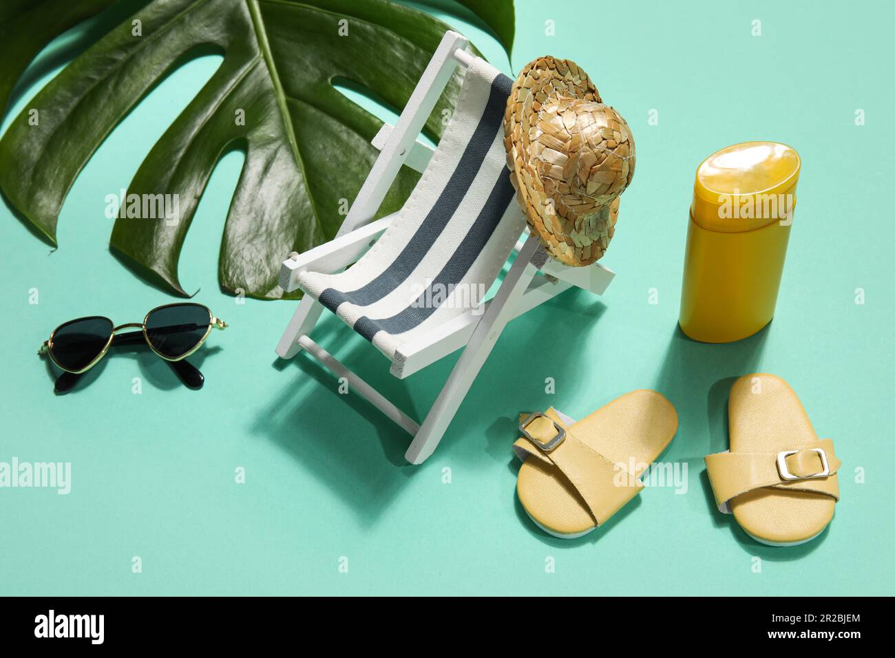 Beach accessories with palm leaf on mint background Stock Photo