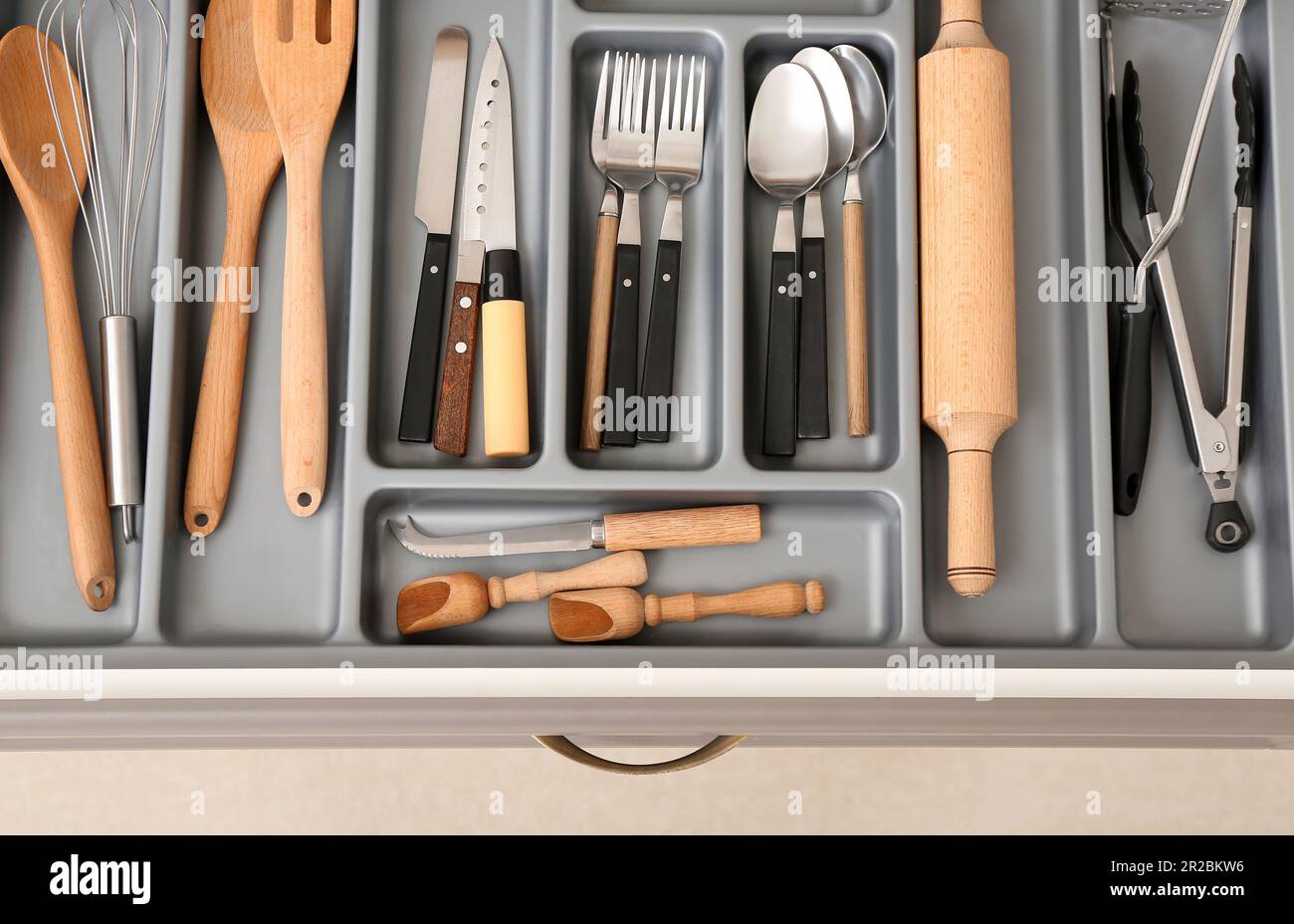Open kitchen drawer with different silver cutlery Stock Photo - Alamy
