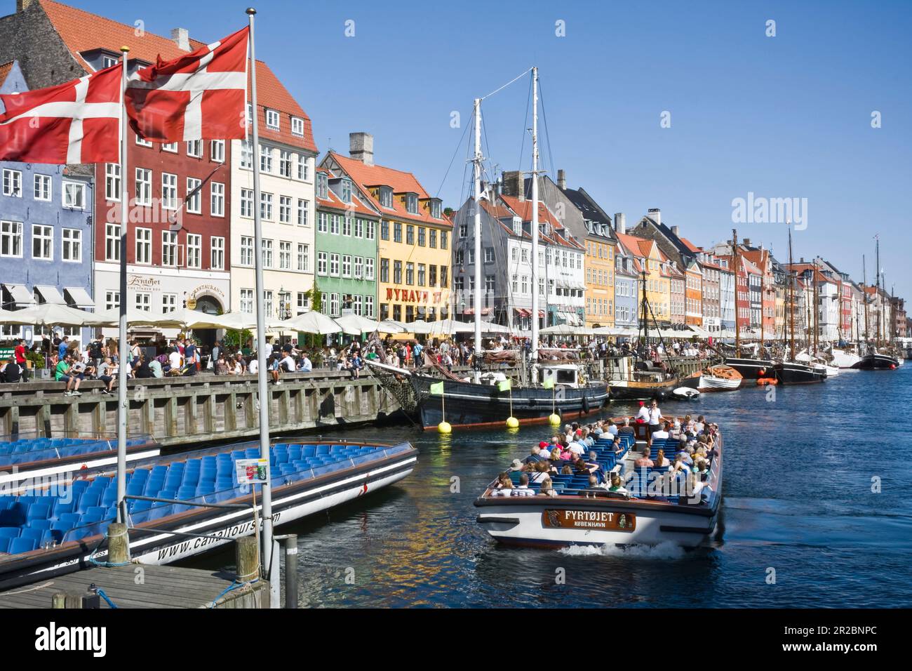 Canal tours at the landmark Nyhavn at Copenhagen, Denmark is a tourist sightseeing tradition Stock Photo