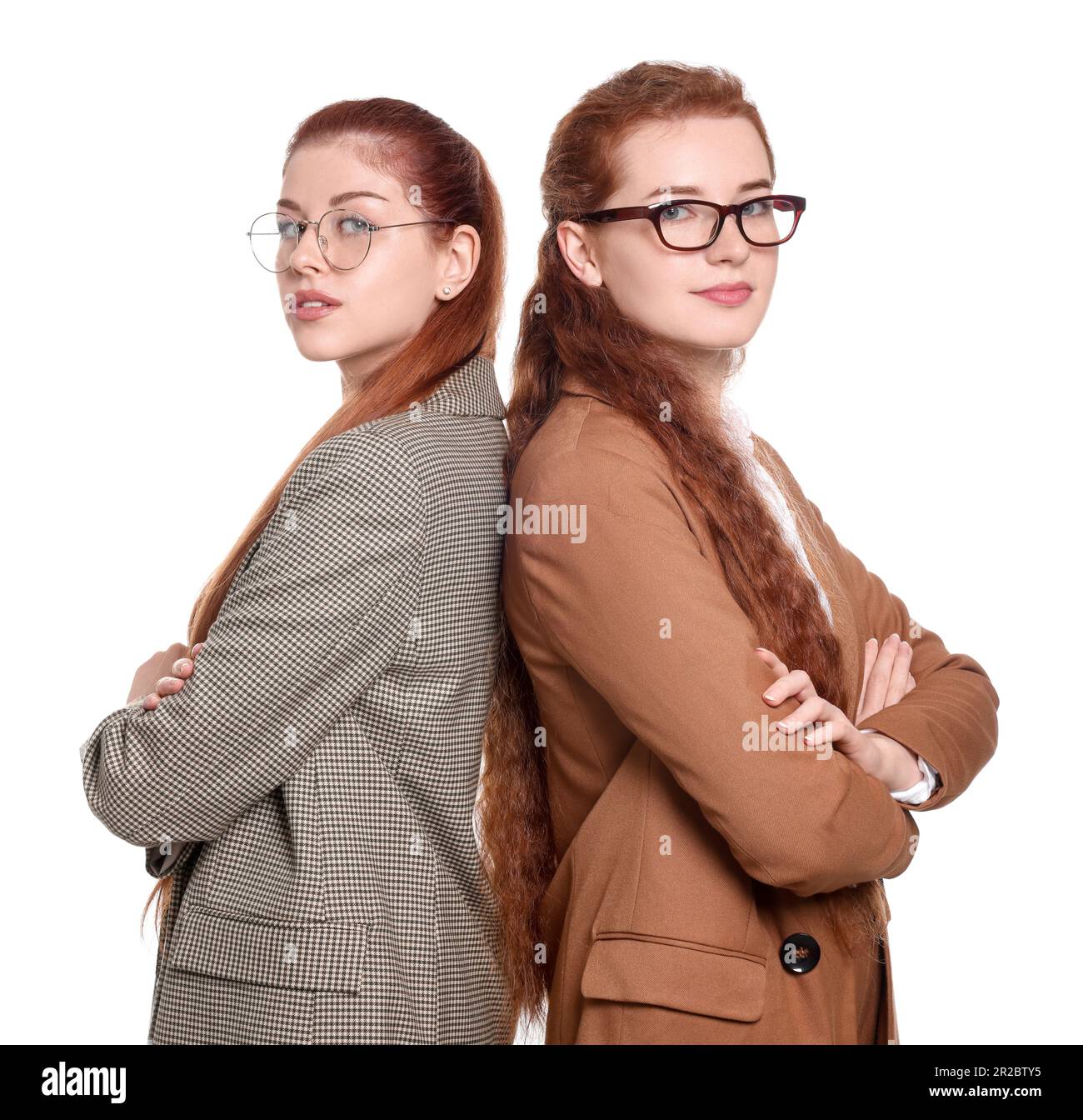 Portrait of beautiful young redhead sisters on white background Stock