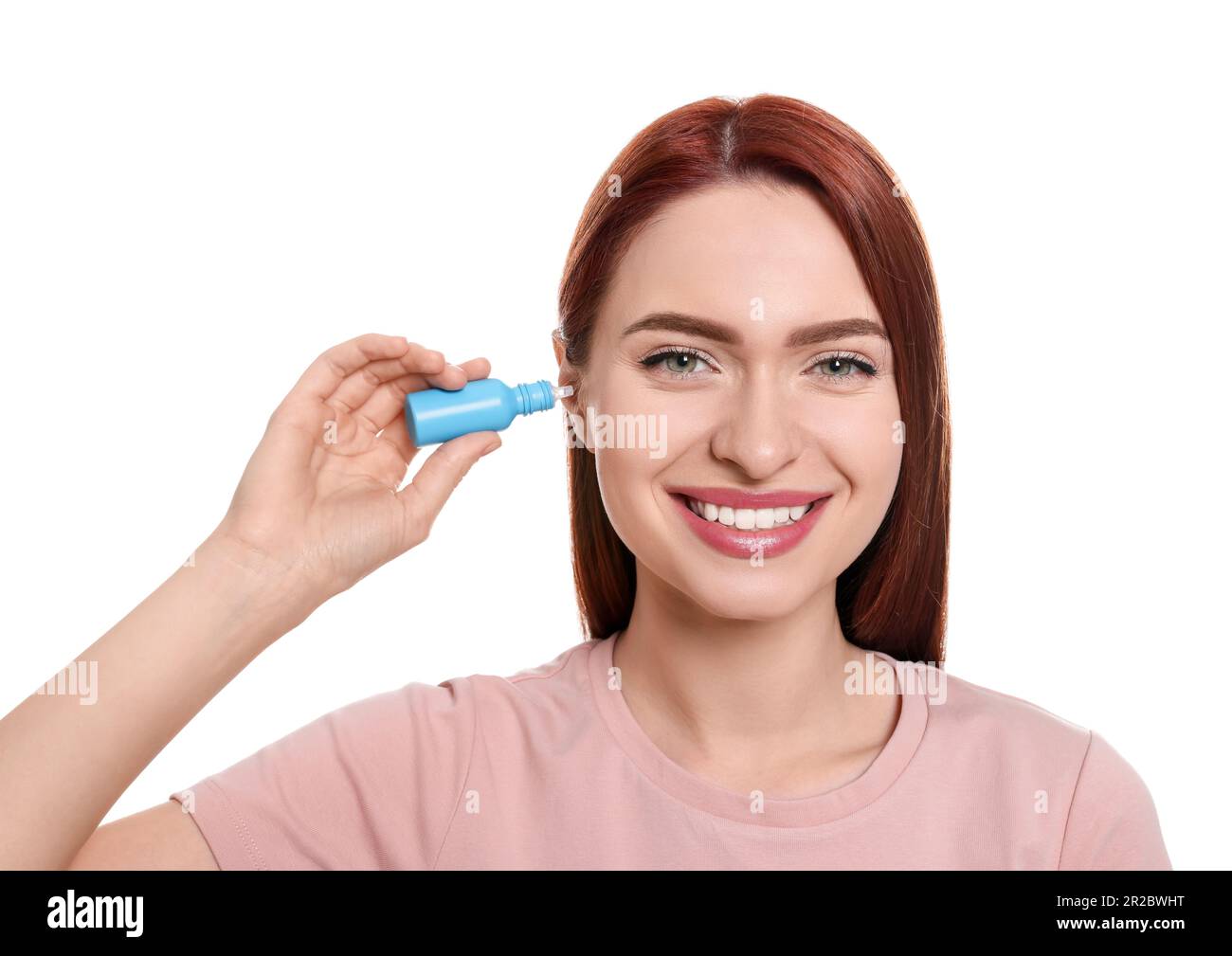 Woman using ear drops on white background Stock Photo Alamy