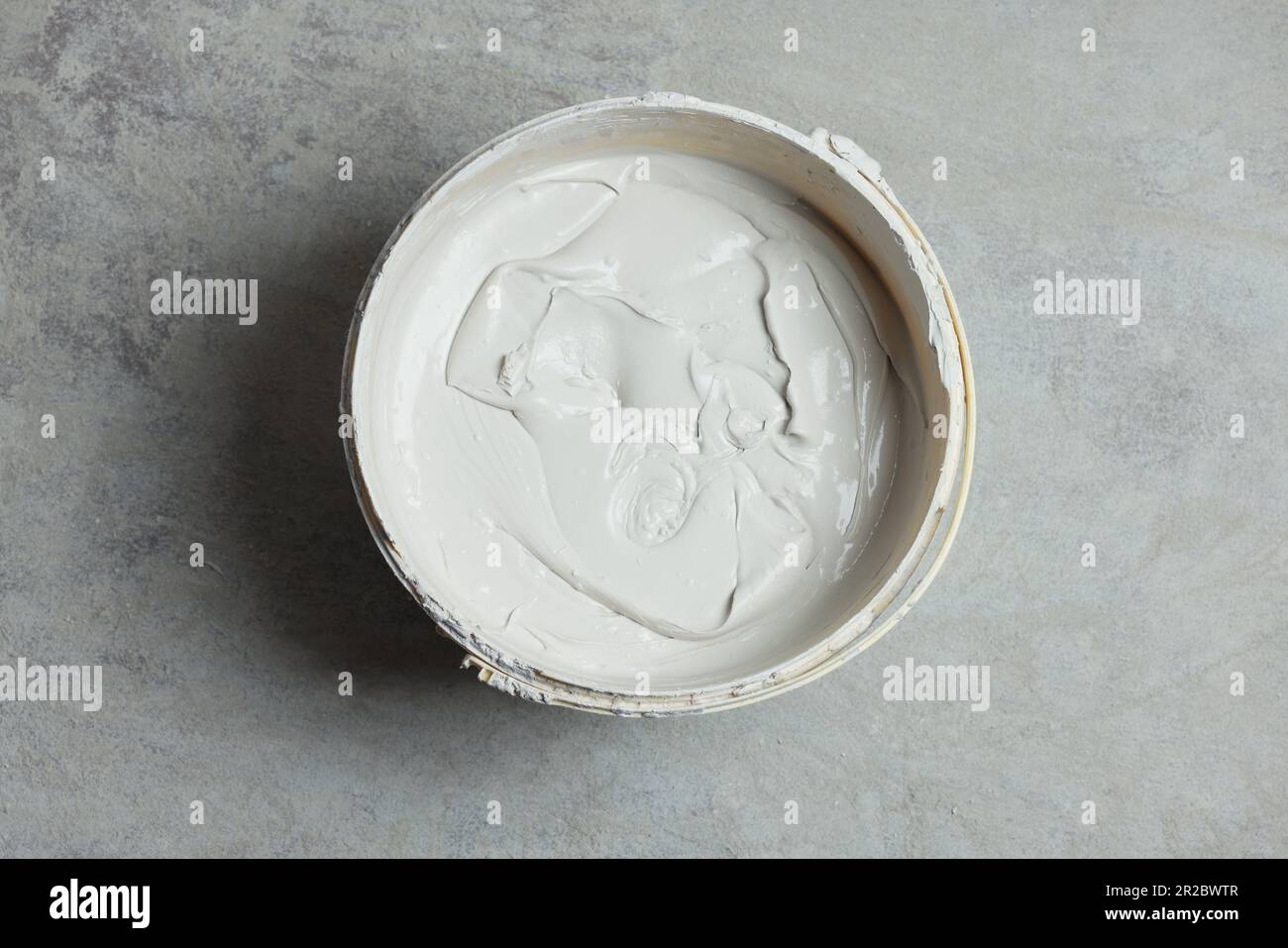 Bucket with plaster on concrete floor, top view Stock Photo Alamy