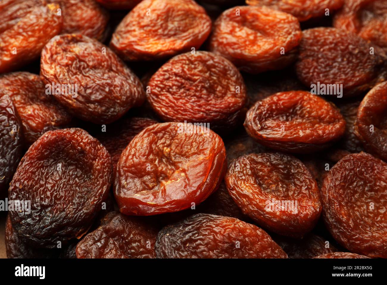 Tasty dried apricots as background, closeup. Healthy snack Stock Photo