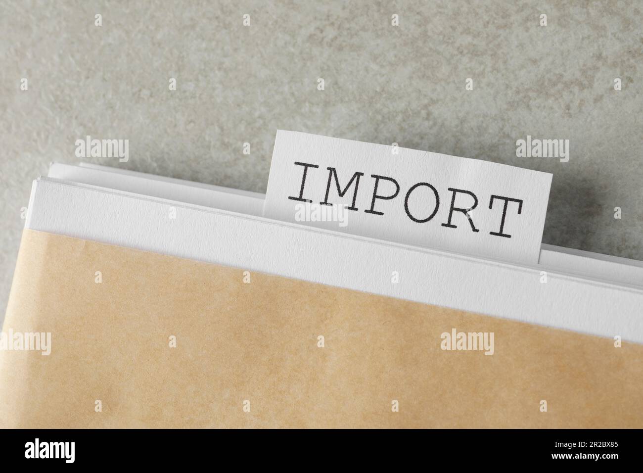 Note with word Import in documentation on light grey table, top view Stock Photo